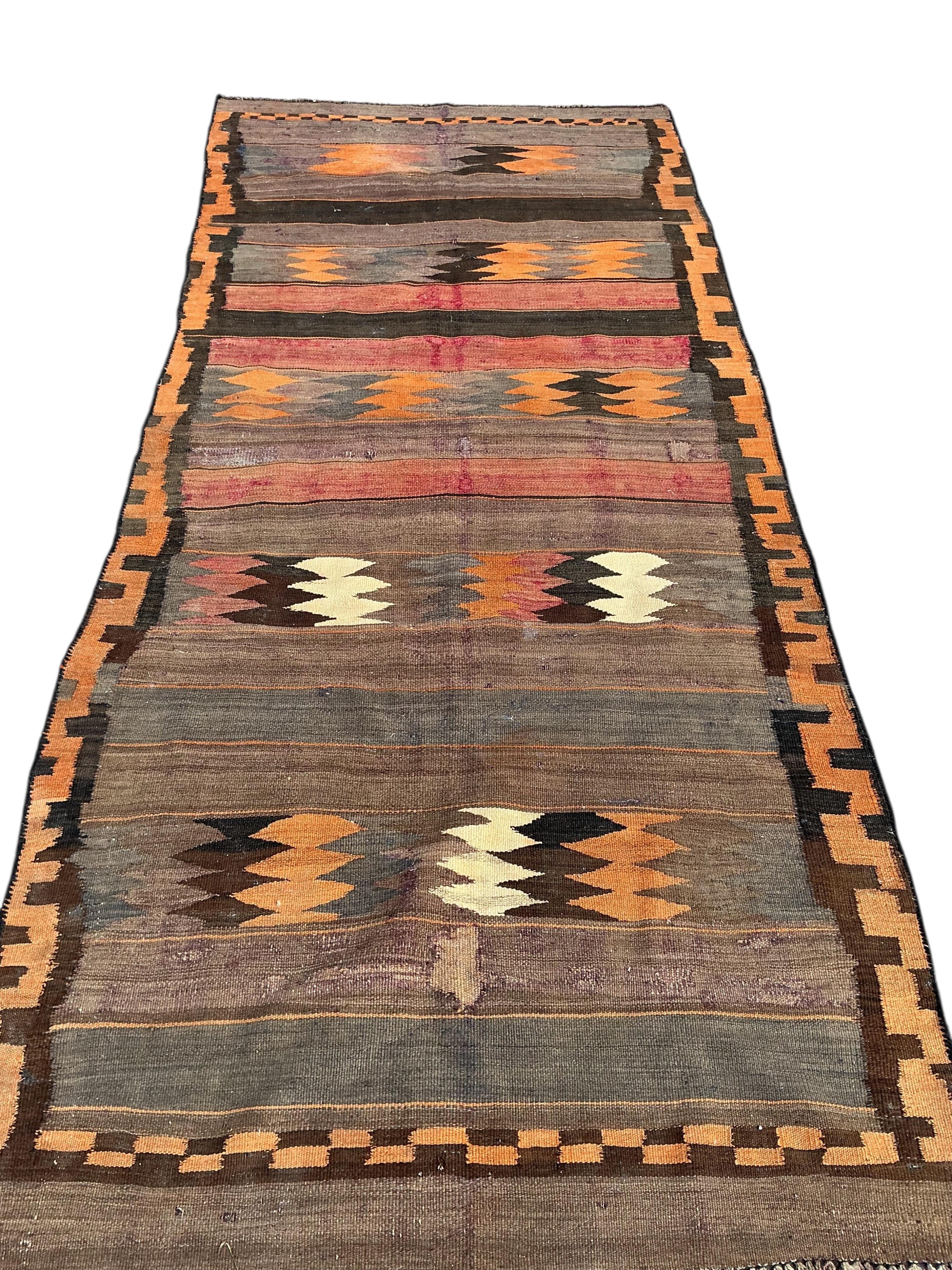 A Turkish kilim flat weave hall carpet, 280 x 120cm